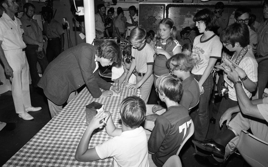 Mark Hamill signs autographs aboard the U.S. Navy destroyer Hammond, docked at Yokosuka Naval Base. Hamill toured the destroyer, patiently scrawling his signature many times for a mob of adoring kids, some of whom wore "Star Wars" T-shirts. 