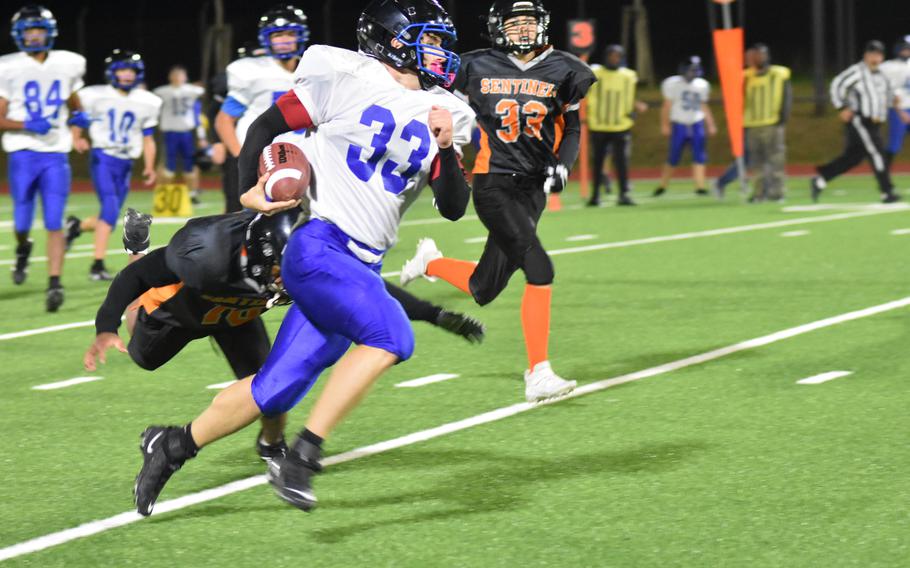 Brussels’ William Pierce eludes a tackle while carrying the ball during the Brigands’ nail-biting, 39-36 win over Spangdahlem in DODEA-Europe Division III football Friday night at Spangdahlem Air Base, Germany. 