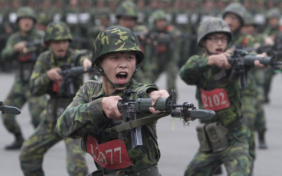 In this photo taken on April 22, 2013, new recruits practice charging with bayonets at a military training center in Hsinchu County, northern Taiwan. 