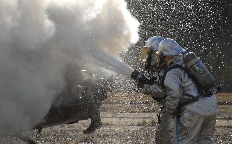 Firefighters extinguish a helicopter fire during a training exercise in 2007. 