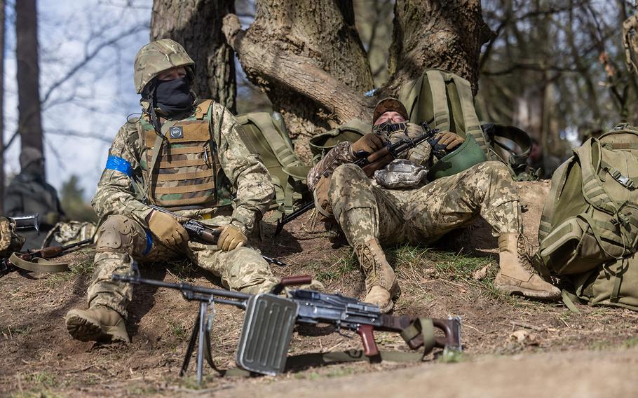 Ukrainian soldiers rest during a military training with French servicemen at a military training compound at an undisclosed location in Poland, on April 4, 2024. 