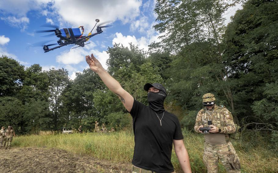 Ukrainian service members train with drones.