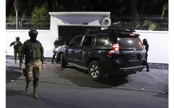 Police attempt to break into the Mexican embassy in Quito, Ecuador, Friday, April 5, 2024, following Mexico's granting of asylum to former Ecuadorian Vice President Jorge Glas, who had sought refuge there. Police later forcibly broke into the embassy through another entrance. (AP Photo/Dolores Ochoa)