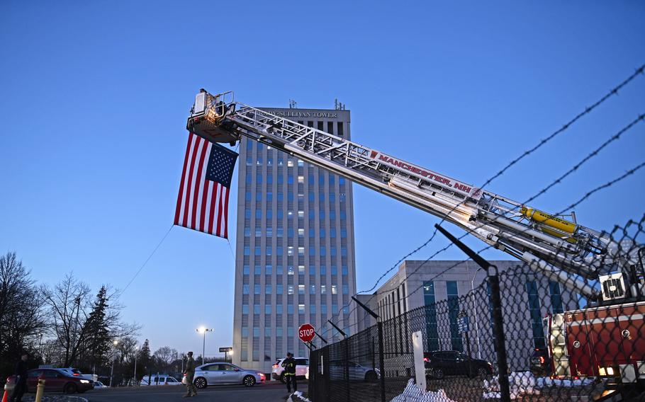 The Manchester Fire Department hoists an American flag over the West Salmon St. entrance to the Manchester Armory for a welcome home ceremony for the 3rd Battalion, 197th Field Artillery Regiment on Feb. 8, 2024, at the Manchester, N.H., armory.