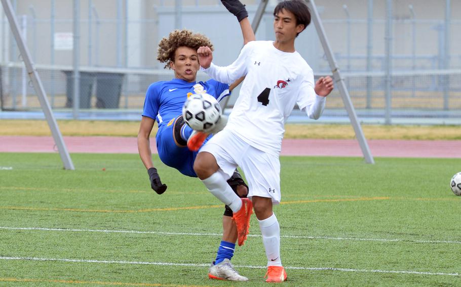 Yokota's Braedan Raybon tries to kick the ball against E.J. King's Axel Lachica during Saturday's DODEA-Japan boys soccer match. The Panthers won 4-0.