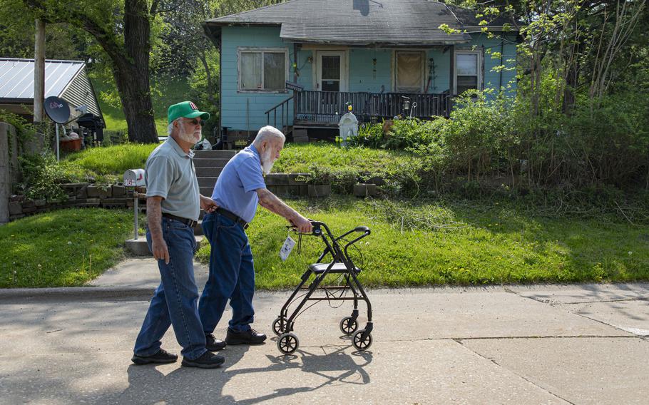 Tanilo Sandoval, 96, walks with his son, Steve, along Hero Street where the family lived for many years in Silvis, Ill.