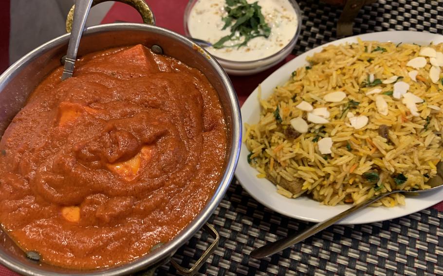 Clockwise from lower left are the butter paneer, raita and gosht biryani rice with mutton at Taj Mahal Ristorante Indiano in Naples, Italy, on April 4, 2022.