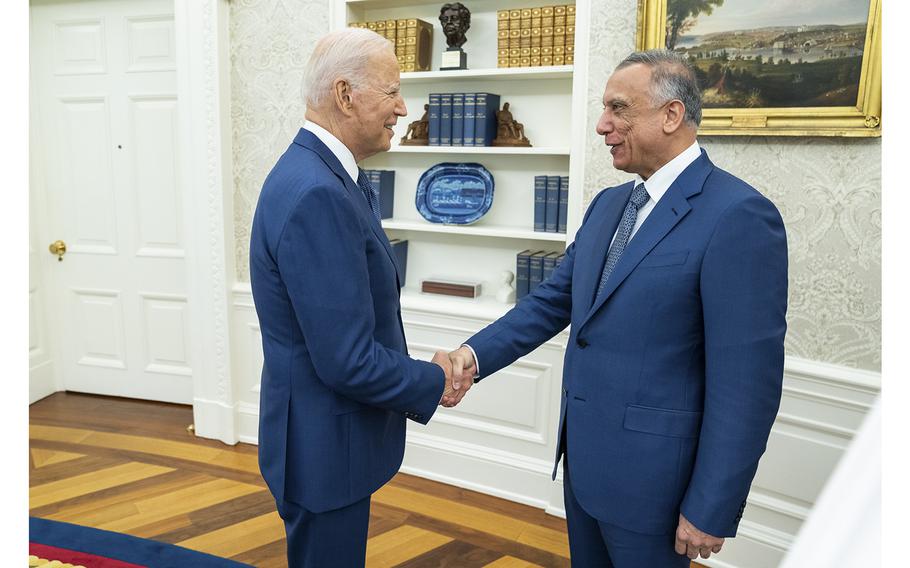 President Joe Biden greets Iraqi Prime Minister Mustafa Al-Kadhimi on July 26, 2021, in the Oval Office of the White House. 