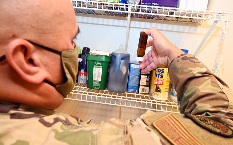 An airman collects a water sample at Joint Base Pearl Harbor-Hickam, Hawaii, Dec. 11, 2021. 