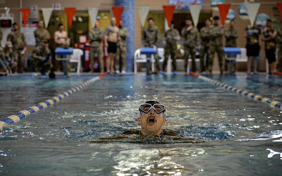 An airman surfaces to catch his breath during the clothed lap swim portion of the German Armed Forces Badge for Military Proficiency at Ramstein Air Base, Germany, April 22, 2024.