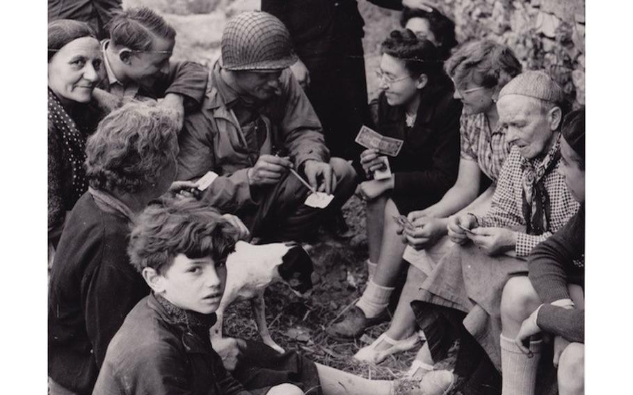 Navy "Beachmaster" Joseph P. Vaghi Jr., with French residents, days after landing on Normandy on June 6, 1944. 