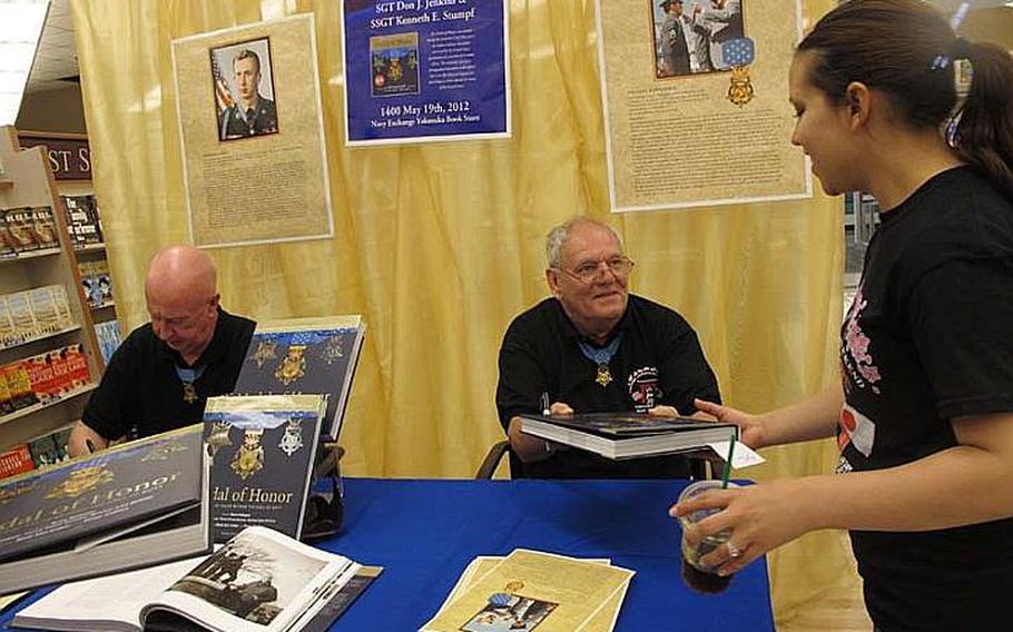 Medal of Honor recipients Don Jenkins, left, and Ken Stumpf, right, sign autographs at the Yokosuka Navy Exchange on May 19, 2012. Each man received the award after saving the lives of their comrades during the Vietnam War. Stumpf died April 23, 2022, at his home in Tomah, Wis. He was 77.