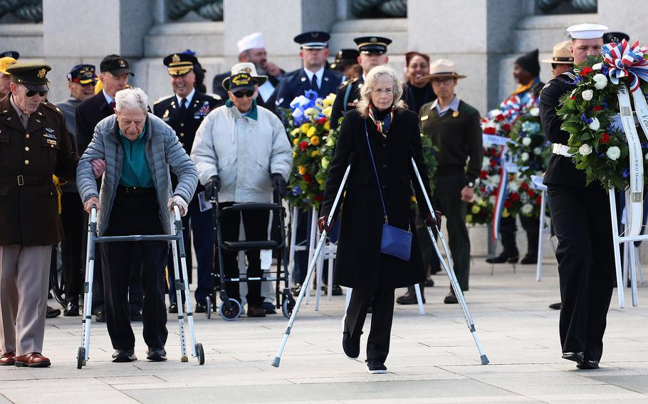 World War II veteran George Arnstein and Friends of the World War II Memorial chair Jane Droppa take part in the wreath-laying ceremony on Veterans Day at the National World War II Memorial in Washington, November 11, 2023.