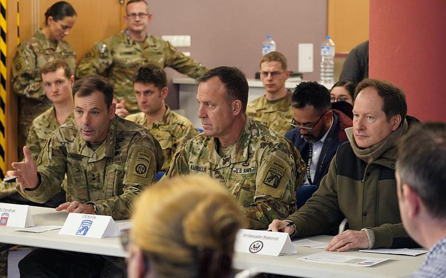 Mark Brzezinski, the U.S. ambassador to Poland, right, listens to 82nd Airborne Division commander, Maj. Gen. Chris Donahue, left, during a briefing in Rzeszow, Poland, Feb. 25. 2022. At center is Lt. Gen. Erik Kurilla, XVIII Airborne Corps commander.