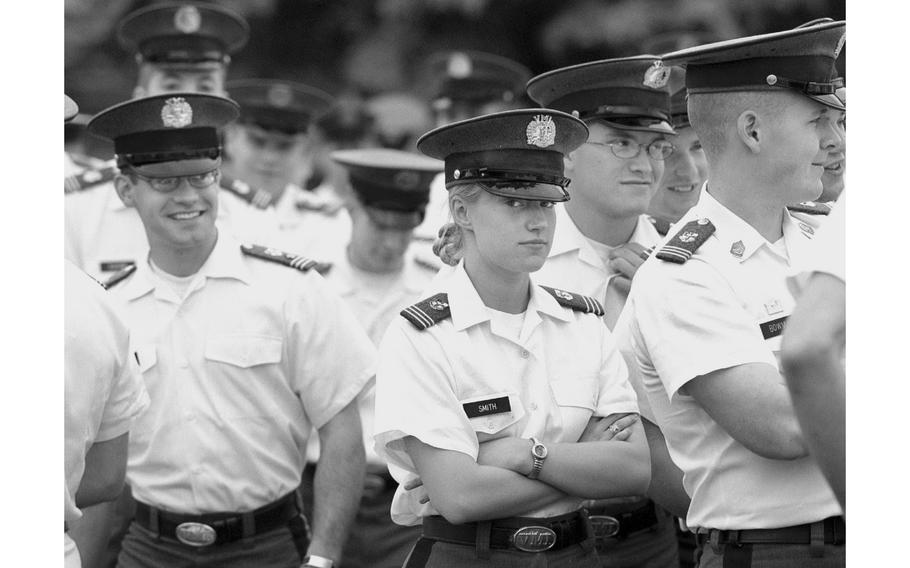 Megan Smith stands with a group of male cadets during graduation rehearsal in 2001. 