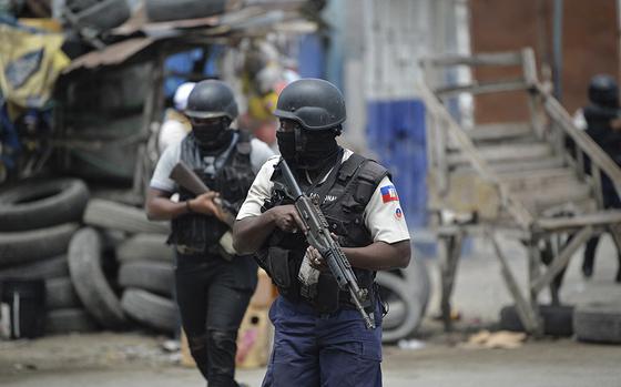 Police officers patrol a neighborhood amid gang-related violence in downtown Port-au-Prince on April 25, 2023. (Richard Pierrin/AFP/Getty Images)