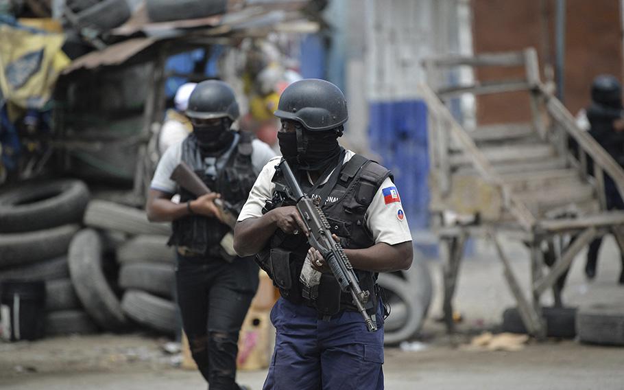 Police officers patrol a neighborhood amid gang-related violence in downtown Port-au-Prince on April 25, 2023. 