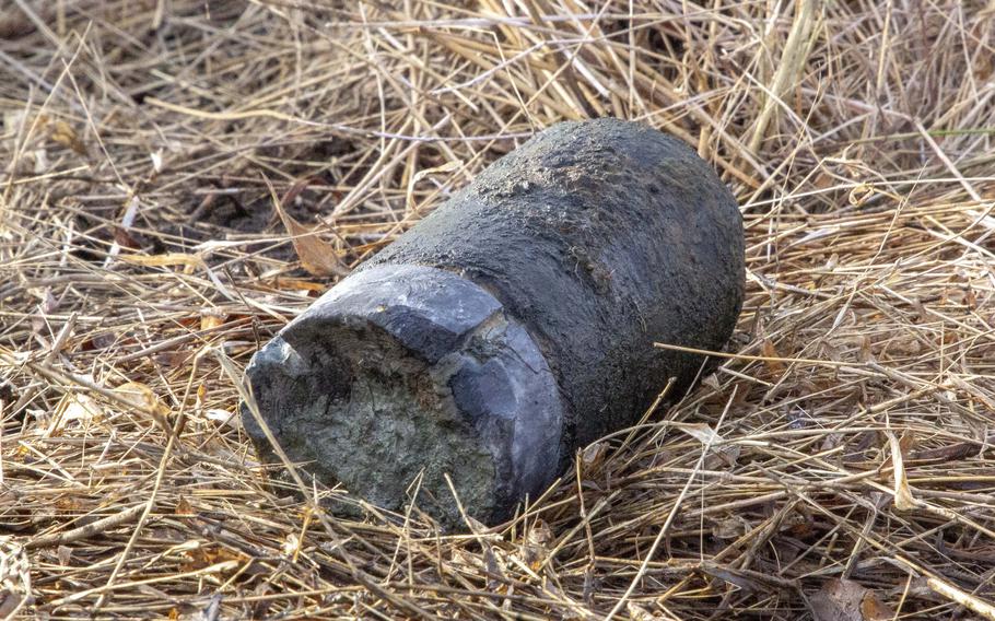 An unexploded three-inch shell casing dating to the Civil War lies on the ground after being unearthed at Gettysburg National Military Park, Feb. 8, 2023. Soldiers with the 55th Ordnance Disposal Company gently washed off the mud to allow park staff to photograph the shell.