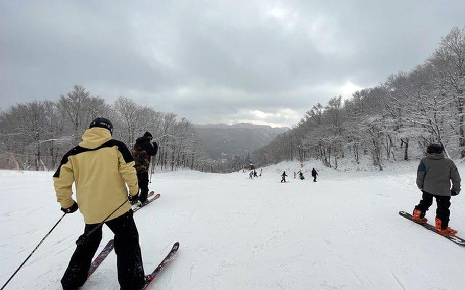 Skiers and snowboarders make their way down a slope this season at Megahira ski resort in Hiroshima prefecture, Japan. 