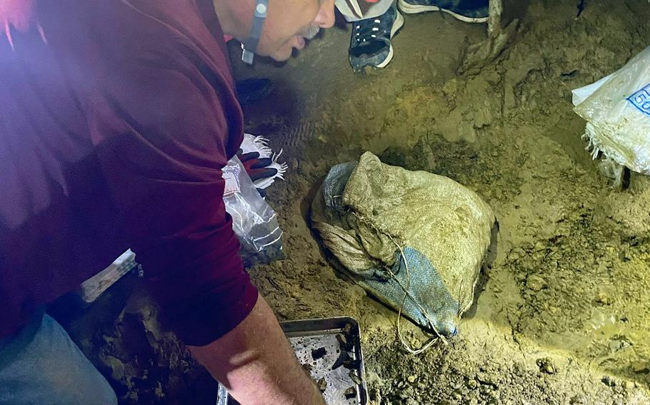 Larry Paleno on Sept. 10, 2022, touches the area inside an Okinawa cave where the remains of his uncle, Marine Pfc. John Quinn Jr., may have been found by the Japanese non-governmental organization Kuentai-USA. 