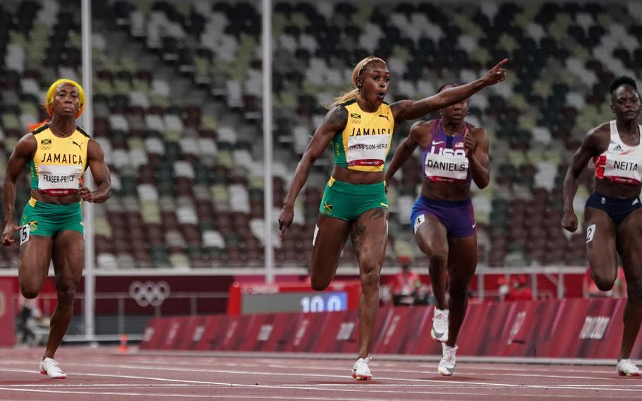 Elaine Thompson-Herah of Jamaica celebrates as she crosses the finish line to win gold in the women's 100-meter final.