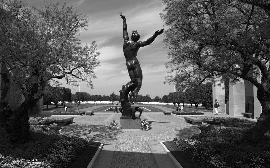 The statue “Spirit of American Youth” rises up from the memorial at Normandy American Cemetery, above the D-Day landing sites at Omaha Beach. 