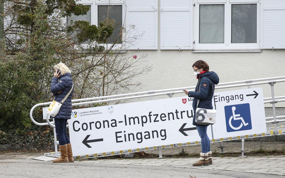 Visitors wait to receive vaccinations for COVID-19 at a vaccine center in Munich on Dec. 2, 2021.