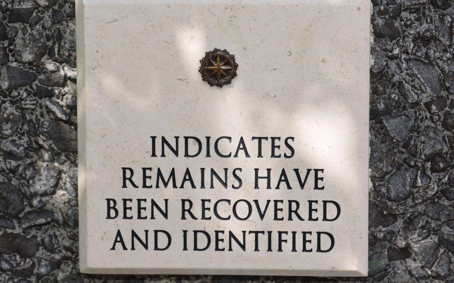 A placard at the Courts of the Missing at the National Memorial Cemetery of the Pacific in Honolulu displays an example of the bronze rosette that is placed beside the names of those whose remains have been recovered and identified.