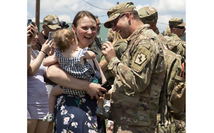 A soldier from the 228th Engineer Company, 337th Engineer Battalion, 55th Maneuver Enhancement Brigade, greets his family after returning home from deployment at Fort Indiantown Gap, Pa. on July 13, 2022. The soldiers were deployed to southwest Asia. 