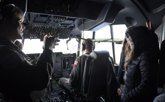 Air Force Master Sgt. Toni Odom takes photos of students inside a C-130J Super Hercules during a Fly Girls excursion over Tokyo, on March 8, 2024. 