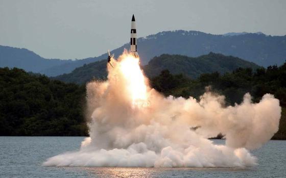 North Korea launches a missile from a submarine in this image released by the state-run Korean Central News Agency on Oct. 10, 2022.