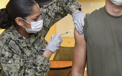 Seaman Denisse Estrada-Suarez administers the Pfizer COVID-19 vaccine to a Marine at Camp Lejeune, N.C., in June. A new medical study found that 23 male service members experienced cases of heart inflammation, a higher rate than expected among the hundreds of thousands who received the coronavirus vaccination. The benefits of the vaccine greatly outweigh the risks, the study concluded. 