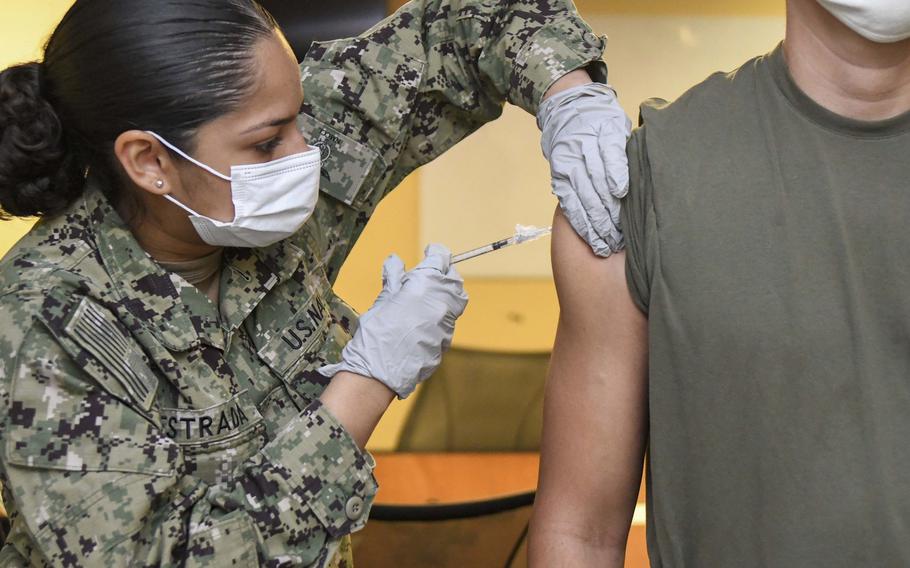 Seaman Denisse Estrada-Suarez administers the Pfizer COVID-19 vaccine to a Marine at Camp Lejeune, N.C., in June 2021.