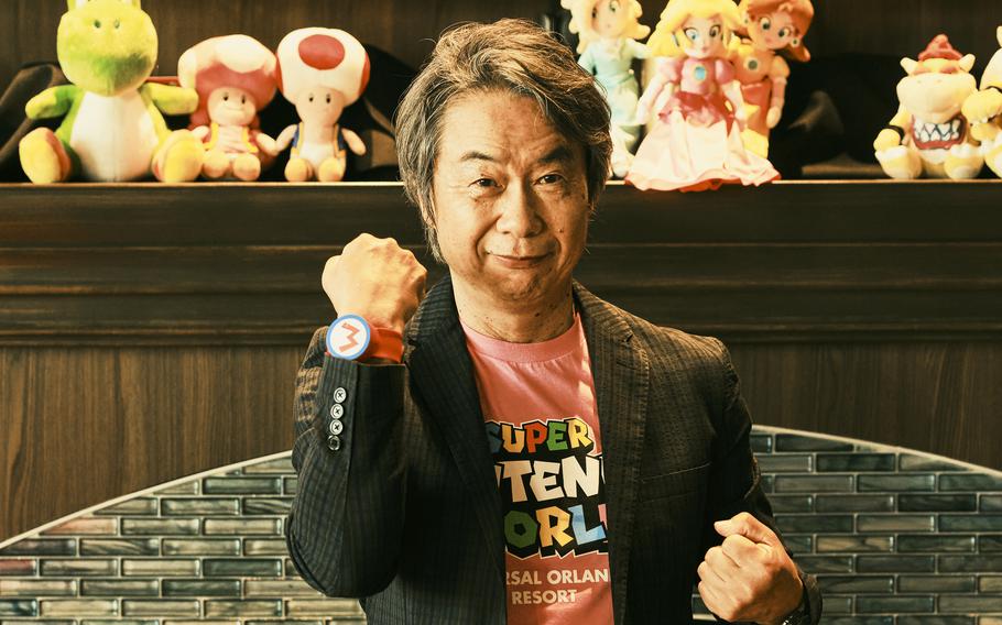 Miyamoto poses with a Mario punch up. 