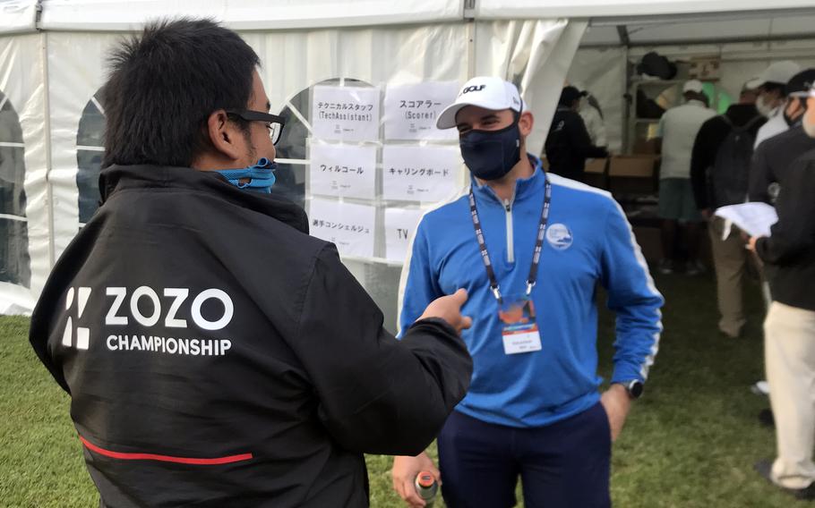 Patrick Bowman, the professional at the Air Force’s Tama Hills Golf Course in Tokyo, speaks with an official ahead of the PGA Tour's Zozo Championship at Narashino Country Club in Chiba prefecture, Japan, Thursday, Oct. 21, 2021. 