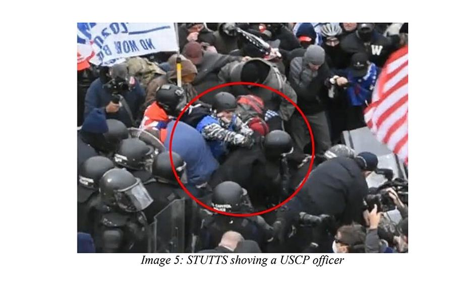 Marine veteran Lee Stutts shoves a U.S. Capitol Police officer in this image from closed-circuit police video included in a criminal indictment against Stutts. 