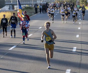 Eventual winner Luke Peterson already has a big lead as he passes Wounded Warrior participants early in the Army 10 Miler on Sunday, Oct. 9, 2022.