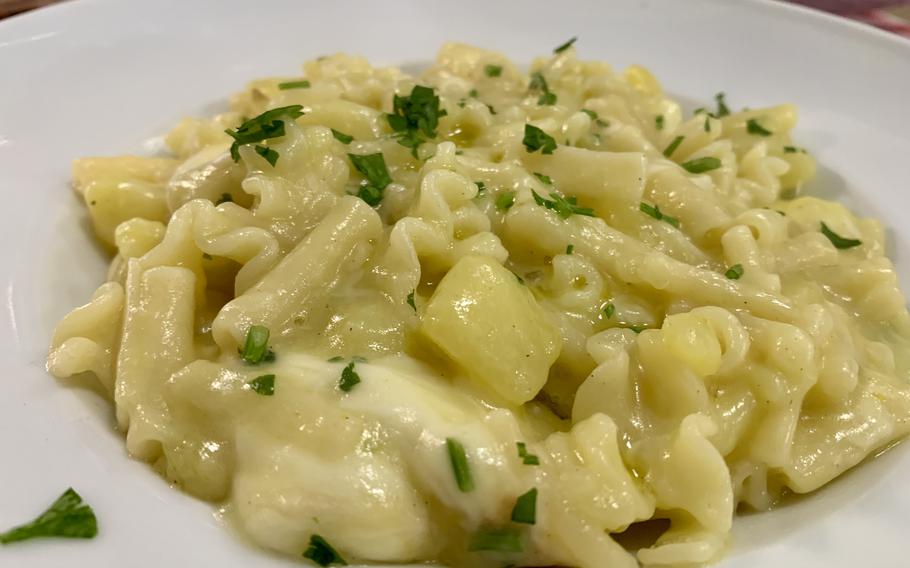 A plate of pasta and potatoes as served at an Italian restaurant.