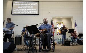 Kris Workman leads a song during the Sunday service at First Baptist Church of Sutherland Springs on Sept. 25, 2022. Kris was paralyzed in the 2017 shooting. MUST CREDIT: Photo for The Washington Post by Lisa Krantz