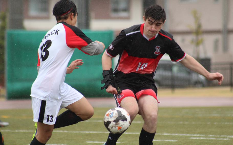 Nile C. Kinnick's Daniel Zurbaran and E.J. King's Jacob Ferrer tangle for the ball during Friday's DODEA-Japan soccer matches. The Red Devils won 10-0.