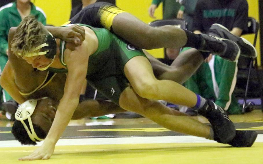 Kadena's James Kinney and Kubasaki's Brady Potter fight for control at 141 pounds during Wednesday's Okinawa wrestling dual meet. Kinney pinned Potter in 2 minutes, 7 seconds, but the Dragons won the meet 39-26.