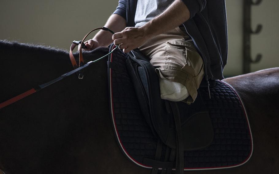 Wounded Ukrainian soldier Danylo Ischenko rides his favorite horse, Bolivia, during a therapy session in Sukhodil, Ukraine, on July 31, 2022.