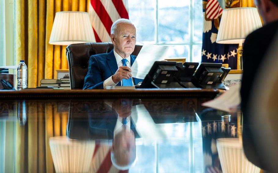 President Joe Biden talks on the phone with King Salman of Saudi Arabia Wednesday, Feb. 9, 2022, in the Oval Office of the White House. 