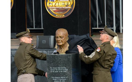 Army Maj. Gen. Paul Stanton, the commander of Fort Eisenhower and the Army Cyber Center of Excellence, right, and Command Sgt. Maj. Michael Starrett unveil a bust of General of the Army and President Dwight D. Eisenhower during a renaming ceremony Friday, Oct. 27, 2023. The former Fort Gordon, Ga., was the last of nine Army bases to be renamed this year to drop their former names honoring Confederate generals. (Corey Dickstein/Stars and Stripes) 