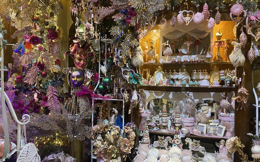 This multifaceted display, which includes Venetian-style carnival masks and various figurines, competes for the attention of shoppers at the Christmas House's store, which has a mesmerizing mixture of things for looks and things for sale. 