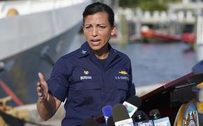 U.S. Coast Guard Captain Jo-Ann F. Burdian details the search of 38 missing migrants at a news conference, Wednesday, Jan. 26, 2022, in Miami Beach, Fla. One migrant was found clinging to the hull of an overturn vessel and one body was recovered off the coast of Fort Pierce, Fla. The migrants left the Bahamas on Saturday in what the Coast Guard suspects is a human smuggling operation. (AP Photo/Marta Lavandier)