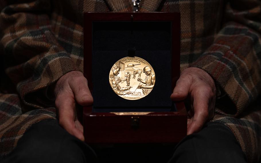 Bernie Bluestein, 100, holds his Congressional Gold Medal before a special ceremony honoring World War II Ghost Army veterans on March 21, 2024. 