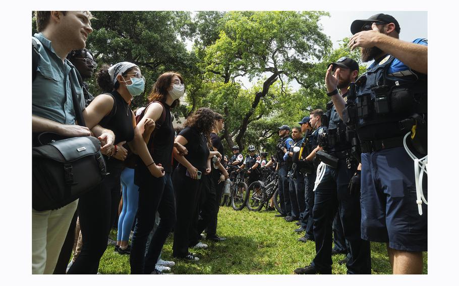 Demonstrators stand off with police officers during a pro-Palestinian protest at the University of Texas in Austin. 