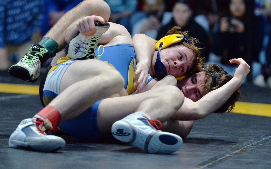 Wiesbaden’s Jacob Lane and Stuttgart’s Zachary Call grapple in the 144-pound final at the DODEA-Europe wrestling championships in Wiesbaden, Germany, Feb. 10, 2024. Lane took the title.