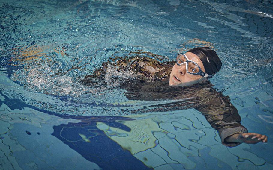U.S. Air Force Capt. Raquel Muscioni, an area defense counsel attorney, competes in the swimming portion of the German Armed Forces Badge for Military Proficiency at Ramstein Air Base, Germany, April 22, 2024. Muscioni and her fellow competitors had to complete the clothed 100-meter swim in under four minutes to move to the next round.